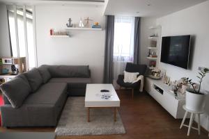 a living room with a couch and a table at Fehér Lótusz Csopak in Csopak