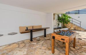a room with a ping pong table and a bench at Gorgeous Home In Popovici With Wifi in Popović +32 photos