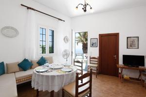 a living room with a table and a couch at VORINI'S HOUSE, Exampela,Sifnos in Katavatí