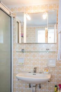 a bathroom with a sink and a mirror at VORINI'S HOUSE, Exampela,Sifnos in Katavatí +22 photos