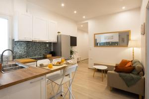 a kitchen and living room with a table and a couch at Casa Lino in Corfu