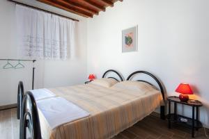 a bedroom with a bed in a room with a window at VORINI'S HOUSE, Exampela,Sifnos in Katavatí