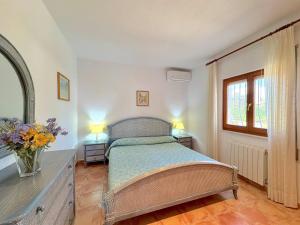 a bedroom with a bed and a vase of flowers at Villa Mar y Sol in Benitachell +52 photos