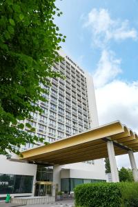 a large white building with a large building at Crowne Plaza Antwerpen by IHG in Antwerp