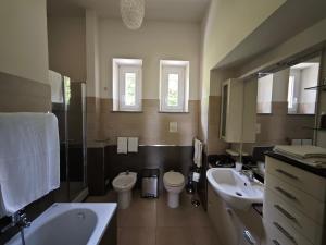 a bathroom with two toilets and a sink and a tub at Cà Somasso in Rivalba +35 photos