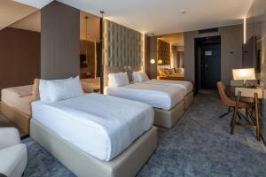 Tempat tidur dalam kamar di Nobel Design Hotel