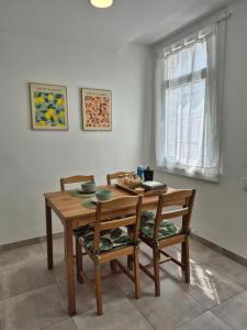 a dining room table with two chairs and a wooden table at Apartamento O Trebello in A Coruña