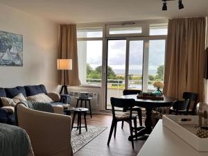 a living room with a couch and a table at Baltic Sea View in Fehmarn
