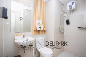 a bathroom with a toilet and a sink and a shower at SheepDream 17BC DeliparkMall 2Bedroom, 1Bathroom in Medan
