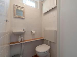a small bathroom with a toilet and a sink at Holiday Home near Sint Maartenszee Beach in Sint Maartensvlotbrug +13 photos