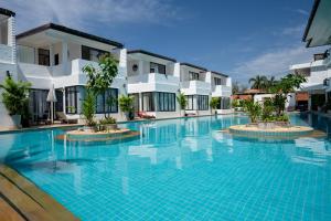 a swimming pool in front of a hotel at Sai Naam Lanta - Apartments & Townhouses in Ko Lanta