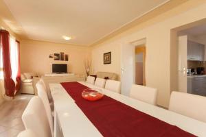 a dining room and living room with a table and chairs at Ferienhaus In Rovinj Mit Großer Terrasse in Rovinj