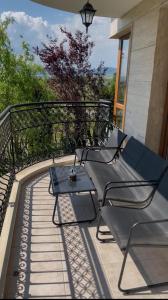 two chairs and a table on a balcony at Nice 2 Room Apartment Harmony Suites 3 Sunnybeach in Sunny Beach +6 photos