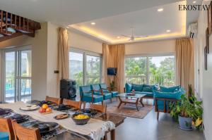 a living room with a table and chairs at EKOSTAY - Casa Den in Igatpuri