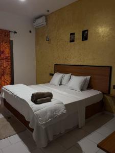 a large bed in a bedroom with a large white bed sidx sidx sidx at Hotel KEUR HORUS in Saint-Louis