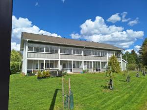 a large white building with a yard in front of it at Einonhovi in Ylivieska
