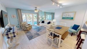 a living room with a table and a dining room at SeaCrest 212 in Fort Walton Beach