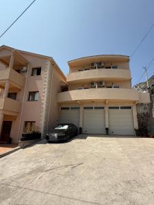 a black car parked in front of a building at Apartments Kankaras - Sea View in Tivat
