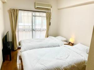 Vuode tai vuoteita majoituspaikassa 鹿鸣新荣