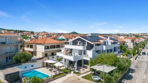 an aerial view of a house with a swimming pool at Apartments 1 with pool and private jacuzzi in Vodice