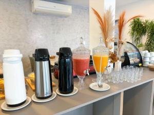 a counter with some drinks and glasses on it at Sunset by AFT - PORTO DE GALINHAS in Porto De Galinhas