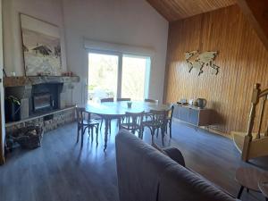 a dining room with a table and chairs and a fireplace at Maison La Roche du Miroir in Plaimbois-du Miroir +16 photos