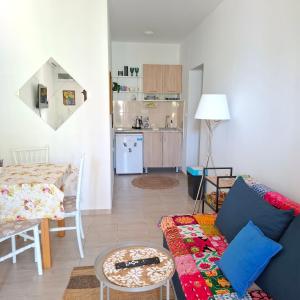 a living room with a couch and a kitchen at Kadena Apartments in Kotor