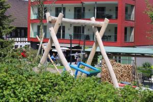 a group of wooden objects in a park at Ferienhotel Bodensee in Berlingen
