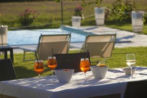 een tafel met glazen wijn en eten erop bij Agriturismo La Collina in Pitigliano