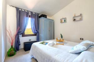 a bedroom with a large bed and a window at Villino Giovanni New 2026 in Costa Paradiso