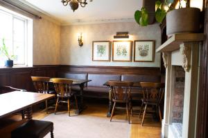 a dining room with wooden tables and chairs at Red Bull in Stockport +35 photos