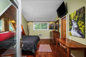 a bedroom with a bed and a desk and a television at Hoffman Woods Estate in West Linn