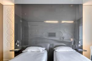 Postel nebo postele na pokoji v ubytování Comfort Aparthotel Bassin d'Arcachon