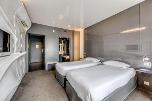 Postel nebo postele na pokoji v ubytování Comfort Aparthotel Bassin d'Arcachon