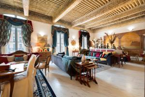 a living room with a blue couch and chairs and tables at Appartement de luxe : Le Petit Trianon au coeur d'Aix-en-Provence in Aix-en-Provence