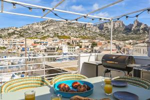 a table with a bowl of fruit on a balcony at Cabin, waterfront terrace in Marseille