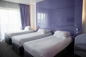 Postel nebo postele na pokoji v ubytování Comfort Aparthotel Bassin d'Arcachon