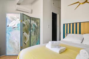 a bedroom with a bed with towels on it at Cabin, waterfront terrace in Marseille