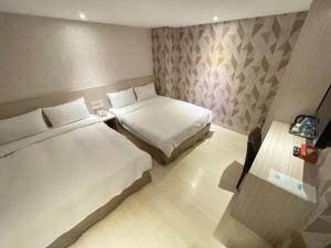 Postel nebo postele na pokoji v ubytování Golden Stone Hotel