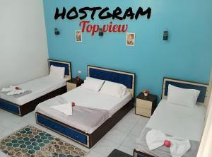 A bed or beds in a room at Hostgram Top View