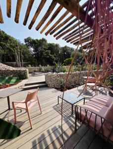 a patio with chairs and a table and an umbrella at Maison Mahana in Bonifacio