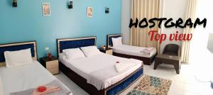 A bed or beds in a room at Hostgram Top View