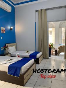 A bed or beds in a room at Hostgram Top View