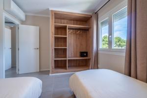 une chambre avec deux lits et une fenêtre dans l'établissement Ponent Cala Ratjada Apartments G, à Cala Ratjada
