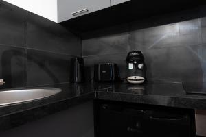 a bathroom with a sink and a coffee maker on a counter at Le Passion Room - Love Room - Jacuzzi in Beauvais