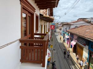 a balcony of a building with people walking on a street at Hotel La Bastida in Marinilla