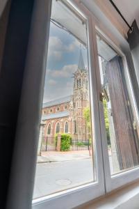 an open window with a view of a building at Le Passion Room - Love Room - Jacuzzi in Beauvais