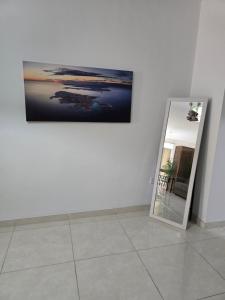 a mirror in a room with a picture on a wall at Cozy 2 Bedroom Steps to Seafront in Il-Gżira