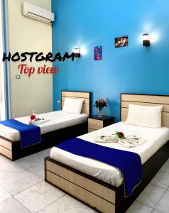A bed or beds in a room at Hostgram Top View