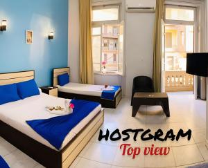 A bed or beds in a room at Hostgram Top View